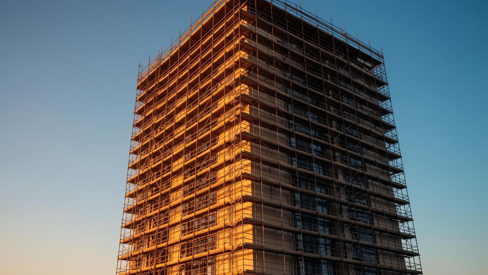 Tube-and-fitting scaffolding erected on a Cornwall building at golden hour by Tubix Scaffolding