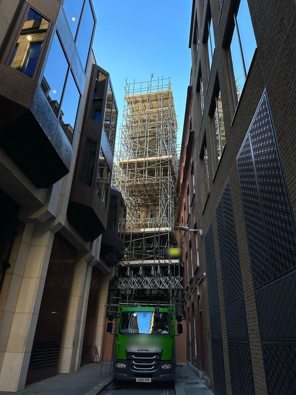 Full-height standing scaffold to a city centre tower with confined service-alley access